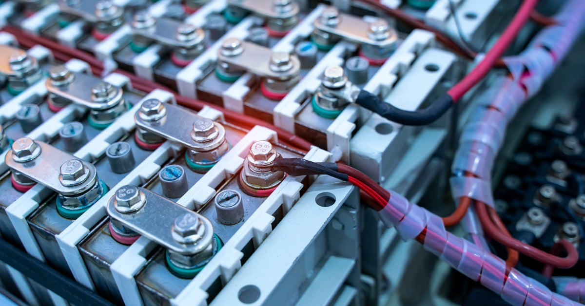Several groups of wired lithium batteries connected by metal tabs bolted into each battery terminal.